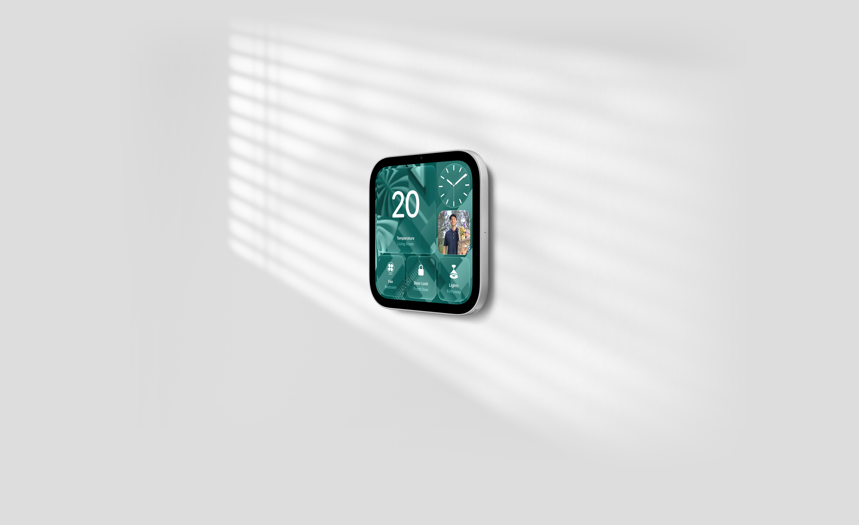 Apple HomeView, wall-mounted model on a wall, silver colour, displaying time, temperature, front door camera feed, and controls for thermostat, bedroom fan, door lock and lights