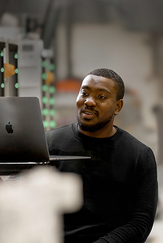 An Apple Operations and Supply Chain team member working on a MacBook.