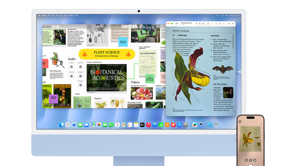 Een iMac en iPhone met kleurrijke content, op de iMac staat de achtergrond van macOS Tahoe.