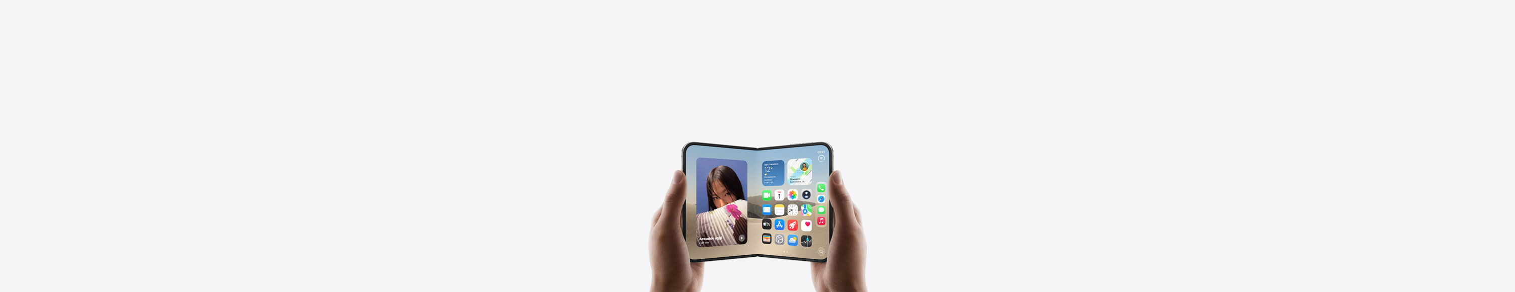 Due mani che tengono un iPhone Duo in orizzontale, aperto, si nota la schermata Home sul display.