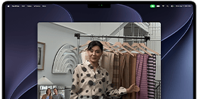 A video call on a MacBook Pro where a woman shows fabrics to two people on the call, with Center Stage keeping her centered in the frame as she moves around