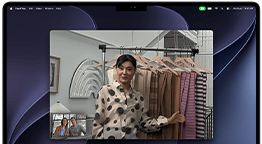 A video call on a MacBook Pro where a woman shows fabrics to two people on the call, with Center Stage keeping her centered in the frame as she moves around
