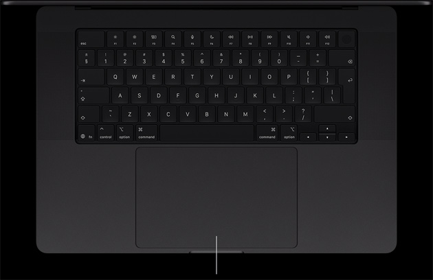 MacBook Pro with PROLED XDR Display, space black color, open, showing keyboard and Force Touch trackpad