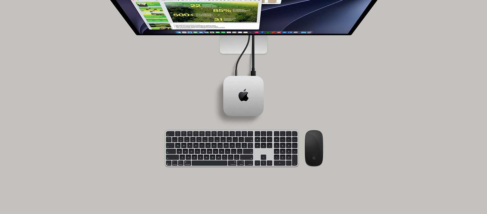 Mac&nbsp;mini, top, silver aluminium, rounded corners, glossy black Apple logo centred, connected by cord, Studio&nbsp;Display partially visible on top, AirPods&nbsp;4, open, Pantone colour swatches and red Logitech keyboard and mouse
