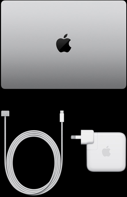 MacBook Pro, silver colour, top, closed, next to charging cable and adapter