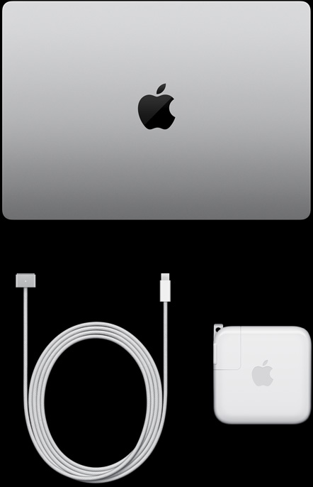 閉合的銀色 MacBook Pro 俯視圖，旁邊擺放著充電連接線與電源轉接器