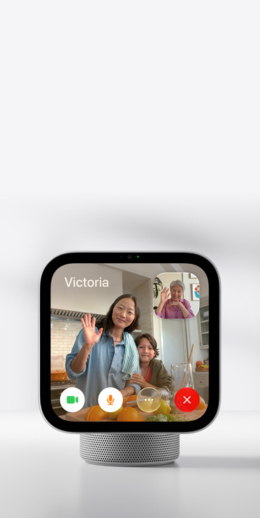 Apple HomeView showing a FaceTime video call with a woman and child waving, and an older woman in the inset window