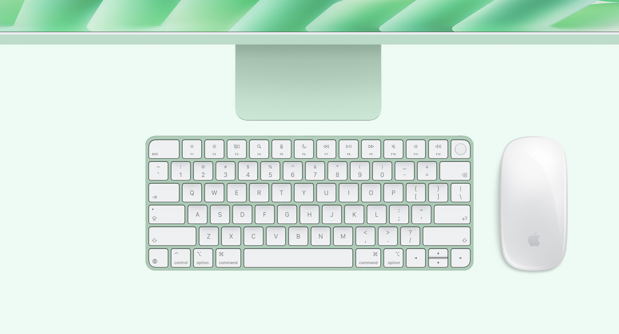 iMac i grøn vist ovenfra med Magic Mouse og Magic Keyboard med Touch ID