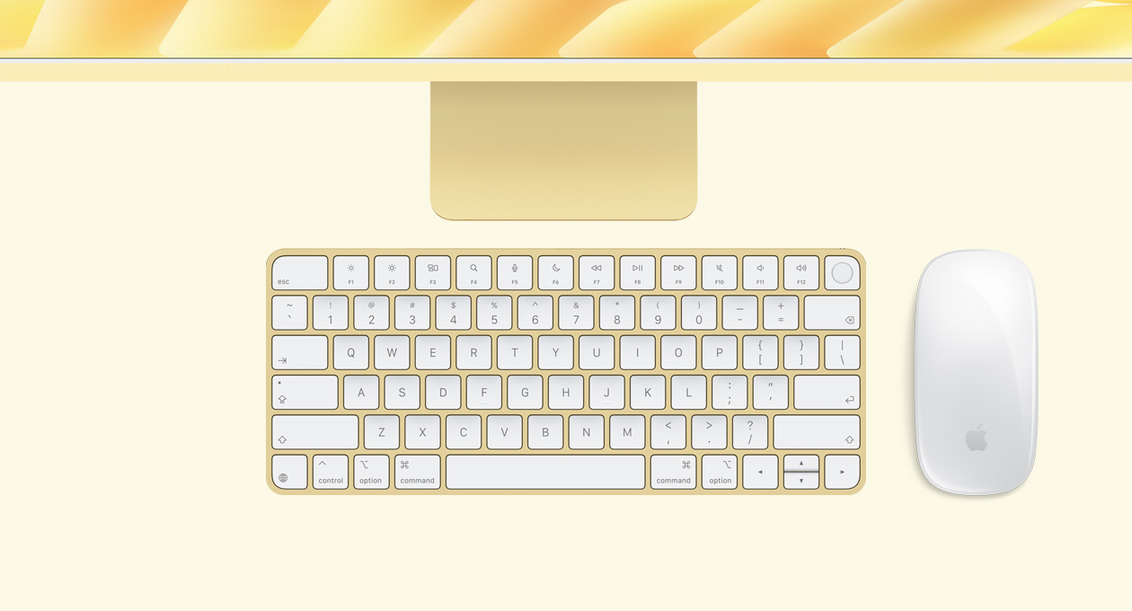 iMac i gul vist ovenfra med Magic Mouse og Magic Keyboard med Touch ID