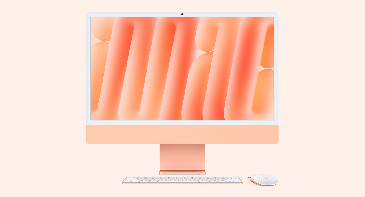iMac i orange vist forfra med Magic Mouse og Magic Keyboard i matchende farver