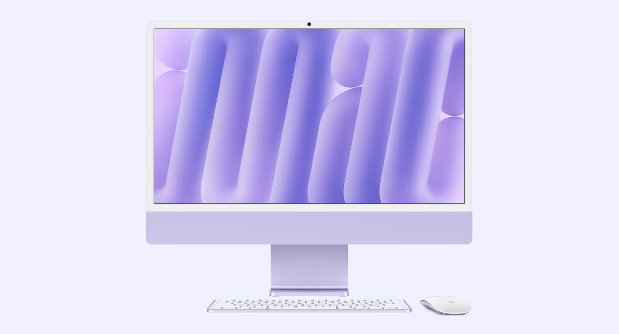 iMac i lilla vist forfra med Magic Mouse og Magic Keyboard i matchende farver