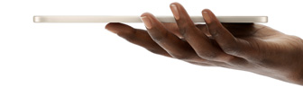 iPad mini, Starlight color, held in hand, thin, light, and ultraportable design.