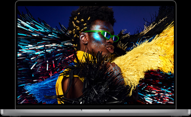 MacBook Pro, silver color, open, display shows image of person