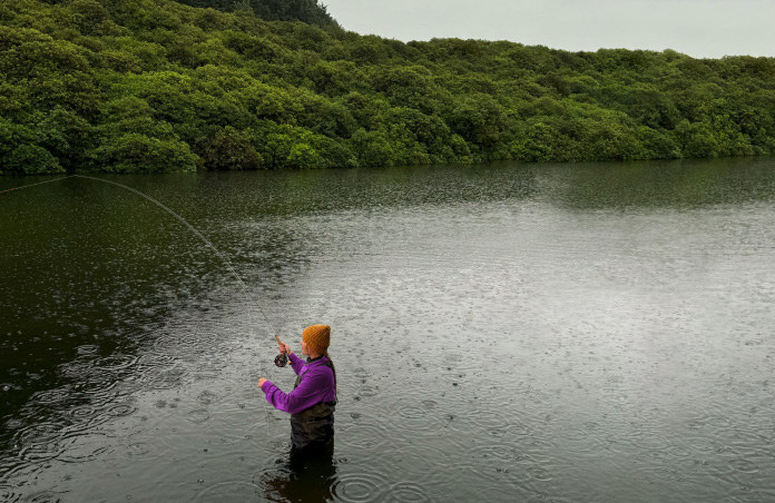 Photo of woman fly-fishing in stream, Pixelmator Pro tool removing unwanted objects